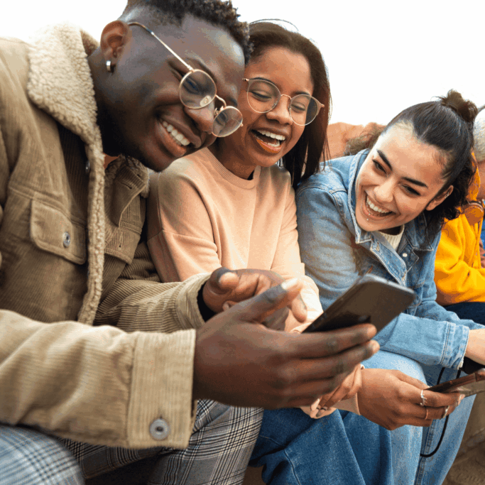 Young_Friends_Laughing_With_Phones